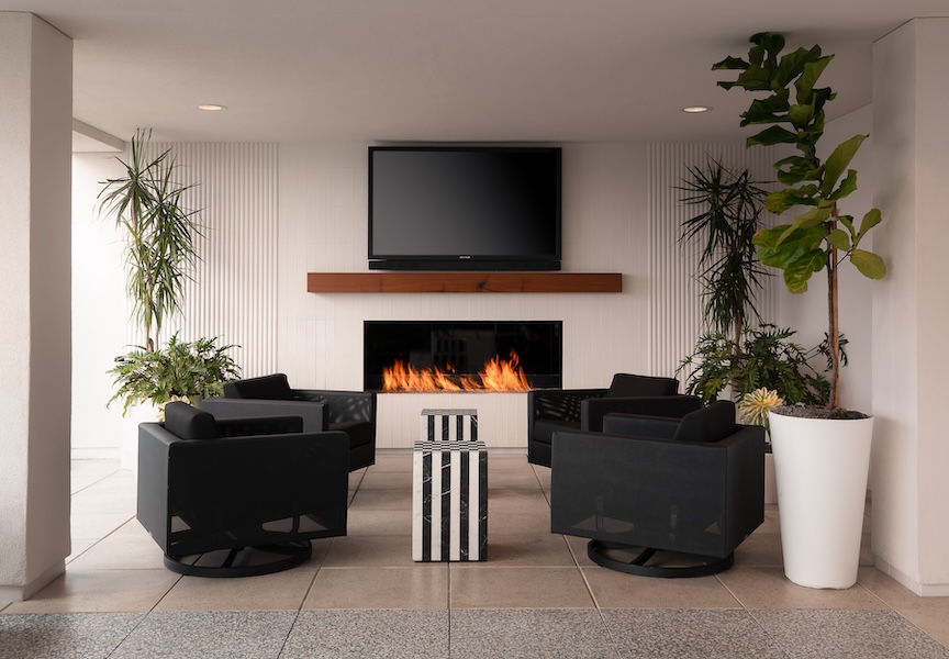 Fireplace seating group at Apollo Apartments by Nadia Geller Designs